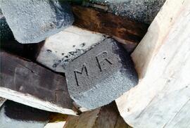 Briqueta de carbón con la letras M R