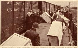 A group of majestic officials watching the loading of a thirty-car train . A day´s production of ...